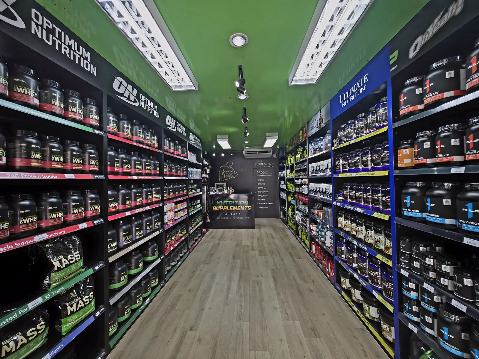 Inside Nutrition Supplements Pattaya on Second Road — shelves of genuine Optimum Nutrition, Rule 1 and Ultimate Nutrition protein and supplements